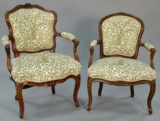 Two similar Louis XV fauteuils, one mid 18th century (with worm damage on front left side)
