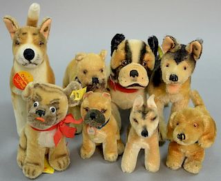 Group of eight Steiff stuffed mohair dogs to include boxer with moveable heads, Hunds, etc. with ear tags.