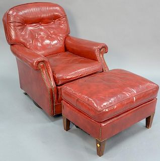 Two piece lot to include red leather swivel chair and ottoman.