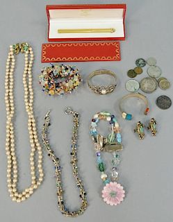 Tray lot with Cartier pen, three necklaces, two silver bracelets, stone bracelet, pair of earrings, and silver dollar and oth