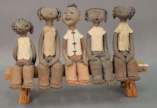 Zheng Yukui (b. 1964) pottery sculpture of five children seated on wood bench. ht. 15 1/2in., lg. 22 3/4in.