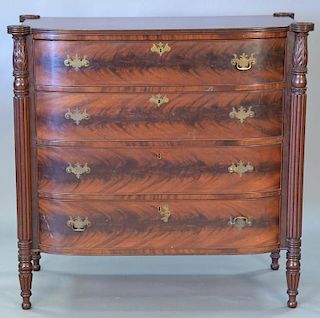 Sheraton mahogany chest of drawers having bowed front and large turret corners, early 20th century (brass pulls missing)