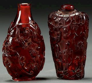 A PAIR OF CHINESE CARVED AMBER SNUFF BOTTLES