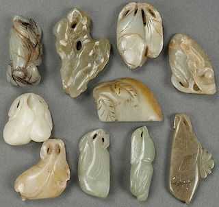 A GROUP OF TEN CHINESE CARVED JADE PENDANTS