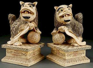 A PAIR OF CHINESE CARVED BONE TEMPLE DOG FIGURES