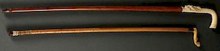 A PAIR OF CARVED IVORY HANDLED RIDING CROPS
