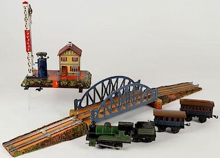 A GERMAN SEVEN PIECE TOY TRAIN AND ACCESSORIES
