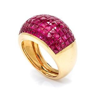 An 18 Karat Yellow Gold and Invisibly Set Ruby Ring, 7.70 dwts.