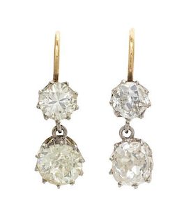 A Pair of Platinum, Yellow Gold and Diamond Dangle Earrings, 1.80 dwts.