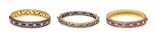A Collection Gilt Silver, Ruby, Sapphire, Emerald and Diamond Bangle Bracelets, 29.90 dwts.