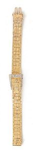 A 14 Karat Yellow Gold and Diamond Buckle Motif Surprise Wristwatch, 24.40 dwts.
