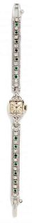 * A 14 Karat White Gold, Diamond and Emerald Wristwatch, Bulova,