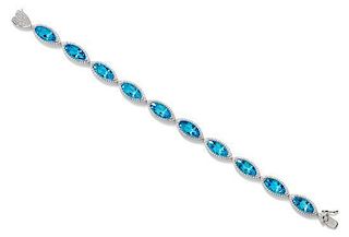 A 14 Karat White Gold, Blue Topaz and Diamond Bracelet, 11.80 dwts.