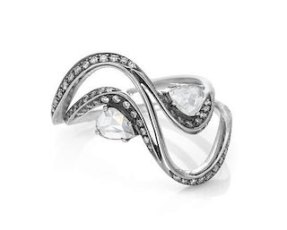 An 18 Karat White Gold and Diamond Swirl Ring, 3.30 dwts.