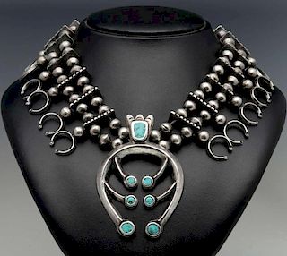 A SQUASH BLOSSOM NECKLACE WITH INLAID TURQUOISE