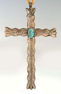 A NAVAJO SAND CAST STERLING AND TURQUOISE CROSS