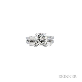 Platinum and Diamond Solitaire, prong-set with a round brilliant-cut diamond weighing 2.40 cts., flanked by tapered baguettes