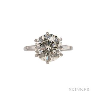 Platinum and Diamond Solitaire, the full-cut diamond weighing 5.31 cts., flanked by tapered baguettes, size 7 3/4.