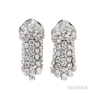 Platinum and Diamond Earclips, each designed as a cascade of oval, baguette, and round brilliant-cut diamonds, approx. total 