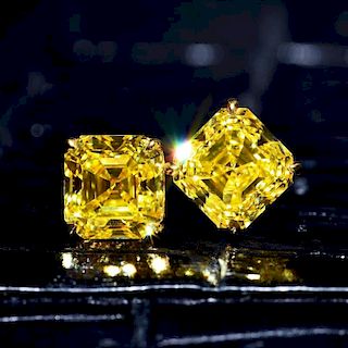 A Pair of Fancy Vivid Yellow Diamond Stud Earrings, with a GIA Report