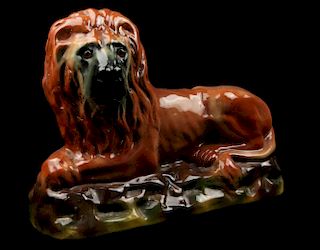 AN EARLY 20TH CENTURY STAFFORDSHIRE POTTERY LION