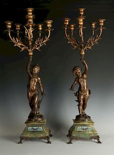 A PAIR OF EARLY 20TH C BRONZE PUTTO CANDELABRA WITH