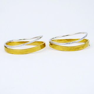 Pair of Pave Set Diamond, 18 Karat White and Yellow Gold Hinged Bangle Bracelets.