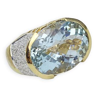 Oval Criss Cross Cut Aquamarine, Pave Set Diamond and 14 Karat Yellow Gold Ring.