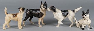 Four painted cast iron dog doorstops.
