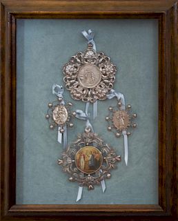 FOUR MOUNTED MEDALLIONS IN A SHADOWBOX CASE