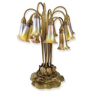 Important Tiffany Studios Twelve-Light Pond Lily Lamp. The pond lily base of dore bronze, the drop cluster blossom design sha