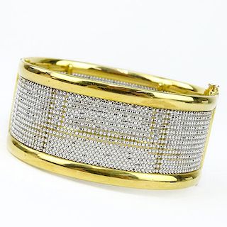 Finely Crafted Italian 18 Karat Yellow and White Gold Hinged Bangle Bracelet. Stamped Italy, 18K and maker's mark.