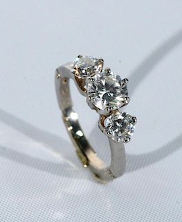 14 karat white gold ring set with three diamonds, center diamond 1.08cts. flanked by .51cts. and .47cts. each, each diamond w