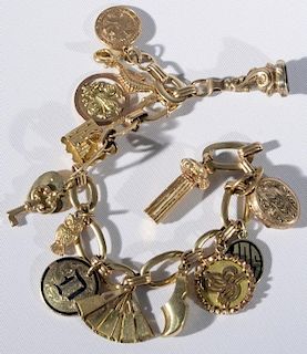 14 karat gold bracelet mounted with 14 karat & 18 karat gold charms. 7 3/8in., 40.4 grams