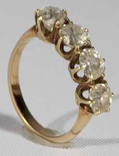 14 karat gold ring set with four diamonds each approximately