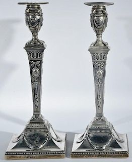 Pair of English silver candlesticks on square bases having wood bases. ht. 12 3/4in.