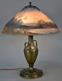 Reverse painted table lamp, The Pairpoint Corp., scenic on metal urn style base. ht. 22 1/2in., dia. 18in. Provenance: Proper