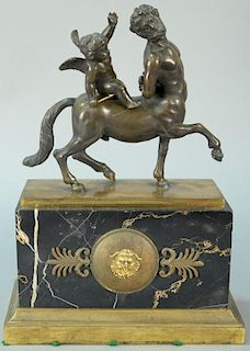 Bronze centaur with putti riding on back, on bronze base, resting on marble, set on bronze foot. ht. 12 1/2in., wd. 9 1/2in.