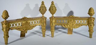 Pair of Louis XVI gilt bronze chenets having urn and pineapple top finials on leaf and fluted legs, 18th - 19th century (one