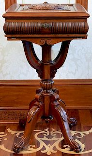 Mahogany stand having carved lift top on pedestal base set on claw feet having felt lined interior. ht. 30in., top: 16 1/2" x