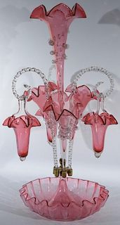 Victorian cranberry art glass epergne having ribbon edge bowl fitted with four ribbon edge vases and three clear glass canes