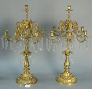 Pair of bronze candelabra, seven light, each with prisms, set on circular bases