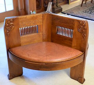 Oak circular conversation settee having three circular seat with spindle back and leather seat cushion set on plain legs with