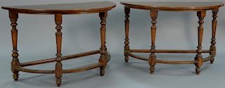 Pair of Continental walnut demilune tables on turned legs with stretchers (made up of old elements). ht. 37 1/4in., wd. 50in.