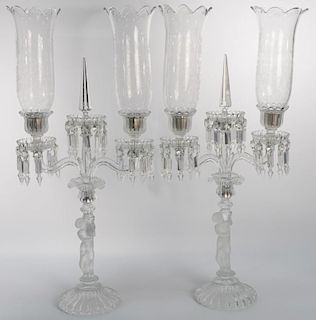 Pair of Baccarat crystal double hurricane candelabras, two light on frosted putti bases, shades marked Baccarat