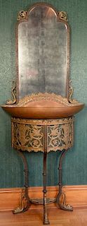 Iron, brass, and copper hall mirror with copper and brass basin on iron legs and brass dolphin feet, previously was fountain