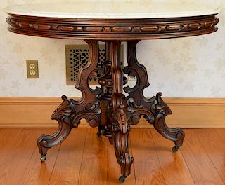 Victorian round marble top table with highly carved base, attributed to Brooks, N.Y. ht. 30 1/2in., dia. 40 1/2in. Provenance