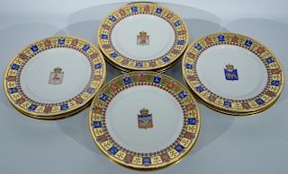Set of twelve Russia Kornilov porcelain dinner plates having gilt red, green, and blue border of various shields and coat of