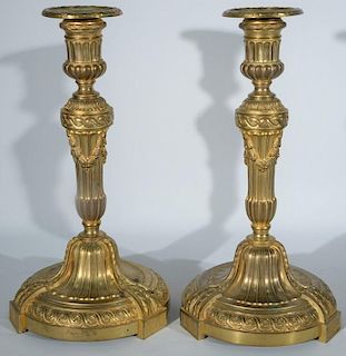 Pair of Ferdinand Barbedienne (1810-1892) Napoleon III gilt bronze candlesticks having large leaf and wreath molded round bas