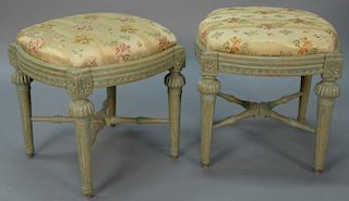 Pair of Louis XVI green painted footstools, each with shaped silk upholstered tops set on carved frames on carved turned and